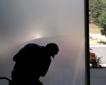Man installing Sunglo's Window Film