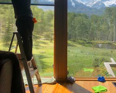 Installing Sunglo's Window Film with ladder while enjoying the view